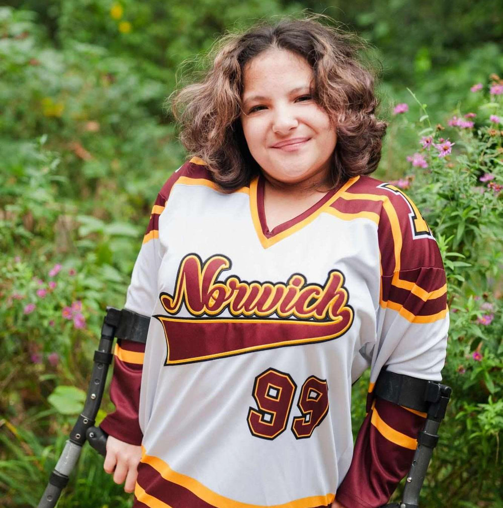 Person in Norwich hockey jersey with crutches.