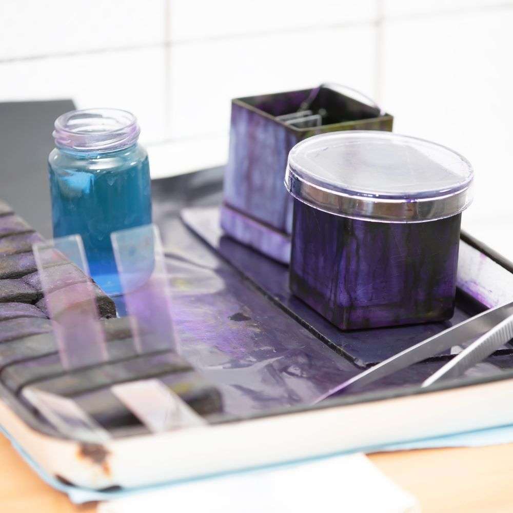 Watercolor painting supplies on a tray.
