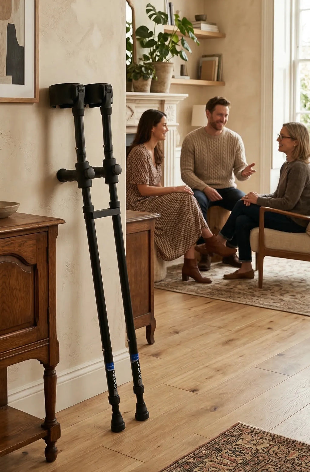 Three people talking in cozy living room setting.