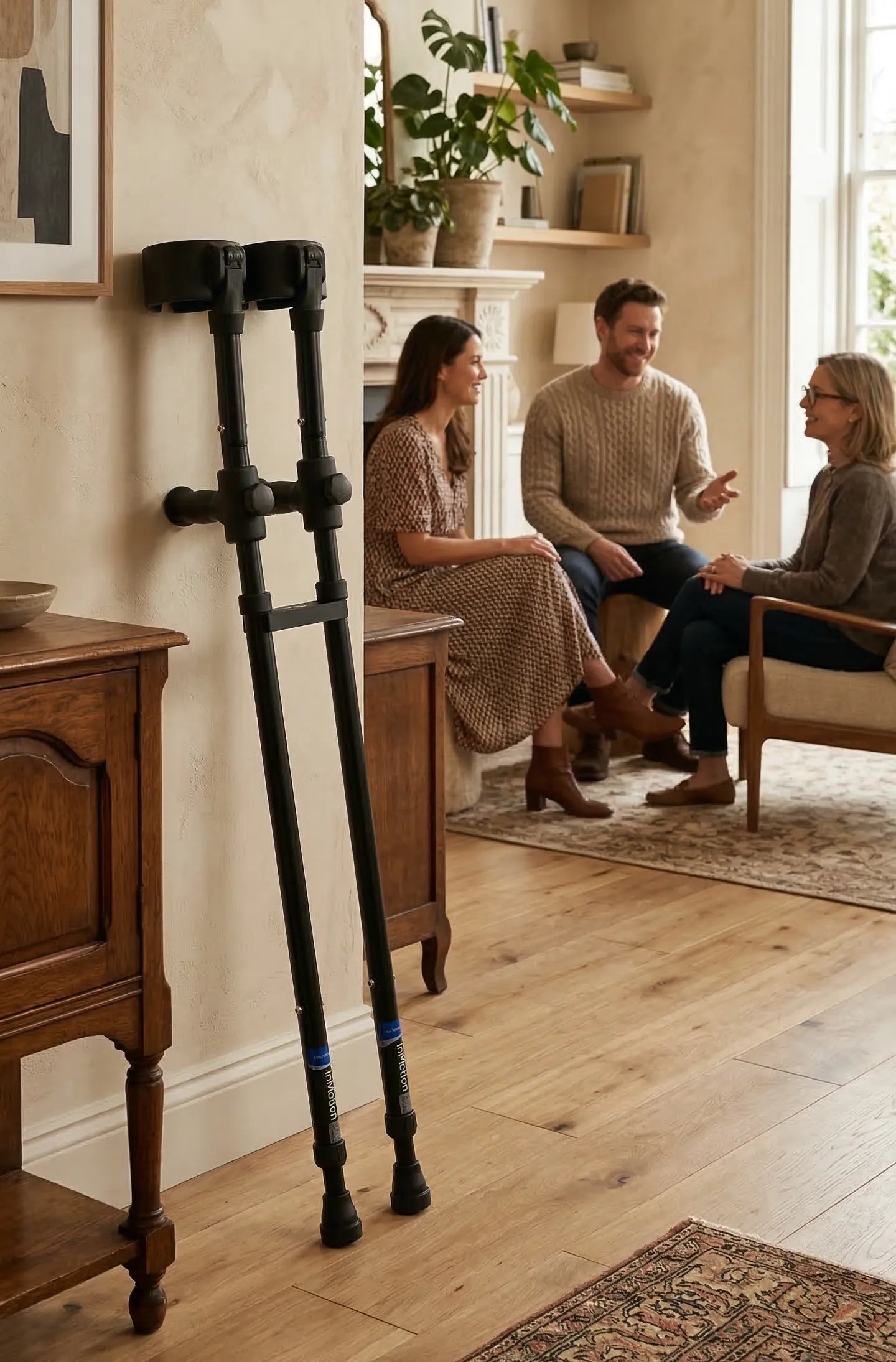 Three people talking in cozy living room setting.