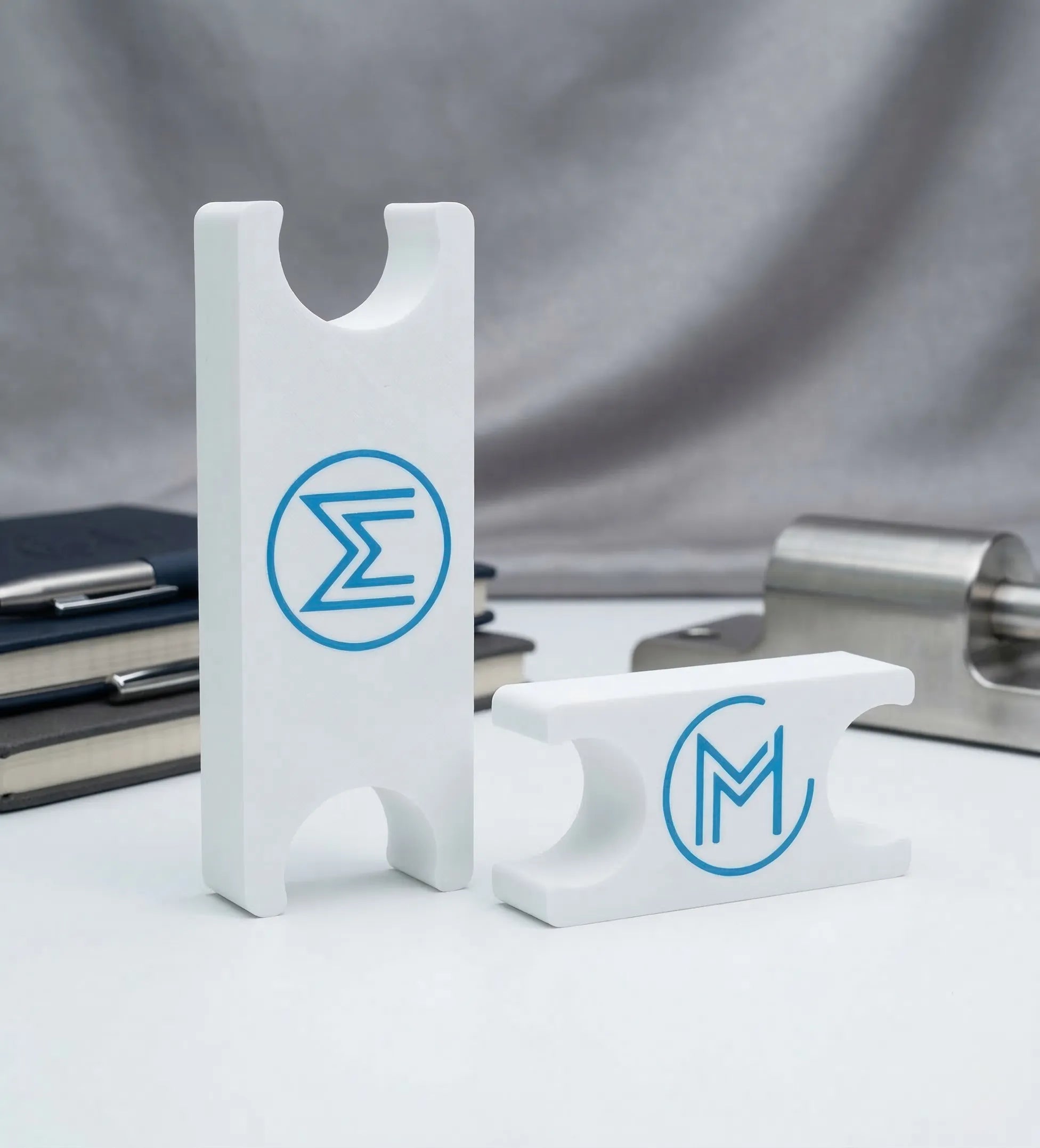 3D-printed white holders with blue logos.