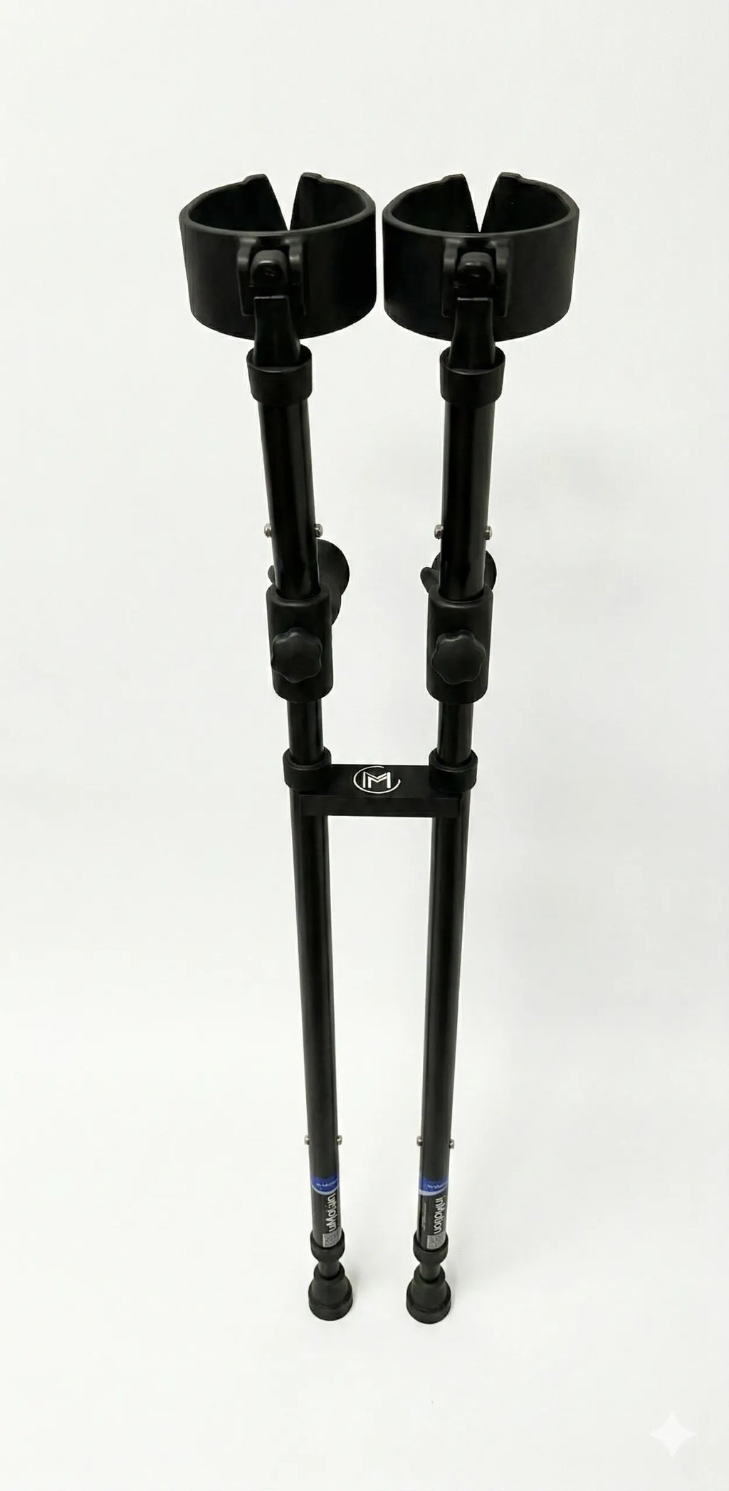 Pair of black forearm crutches on white background.