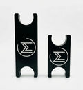 Two black metal pieces with engraved symbols