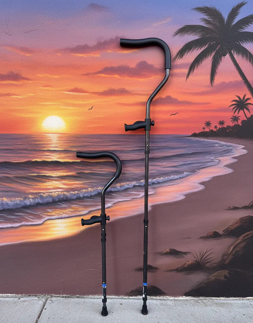 Pair of in-Motion underarm crutches against beach sunset mural background