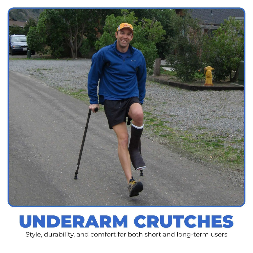 Man walking with underarm crutches on road